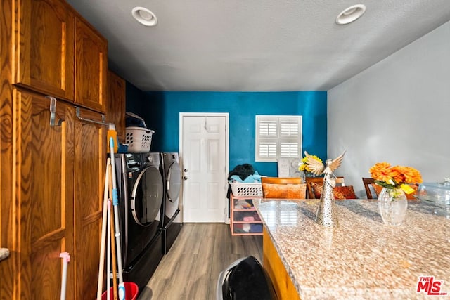 clothes washing area featuring dark hardwood / wood-style flooring, independent washer and dryer, and a textured ceiling