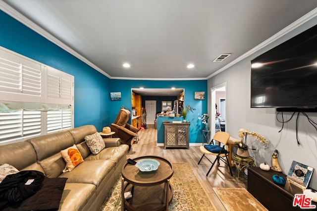 living room featuring light hardwood / wood-style floors and ornamental molding