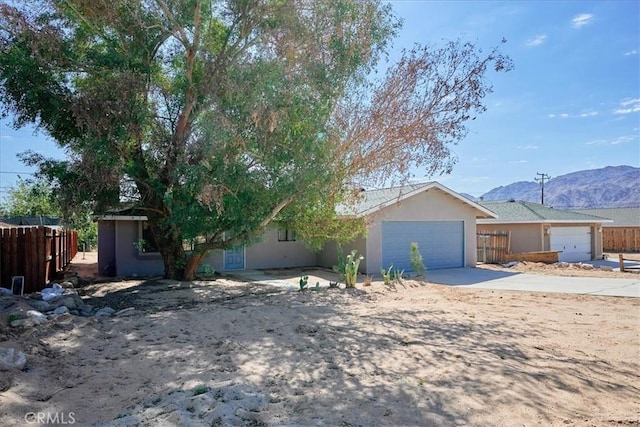 view of front facade featuring a garage and a mountain view