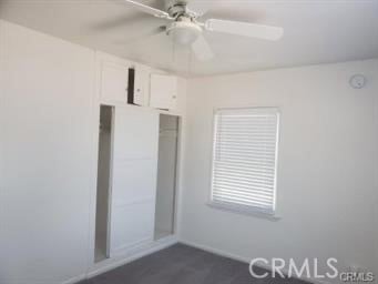 unfurnished bedroom featuring ceiling fan