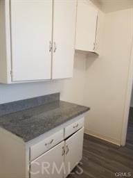 77161/2 Crenshaw Blvd, Los Angeles, CA 90043 - kitchen with dark wood-style flooring and white cabinets