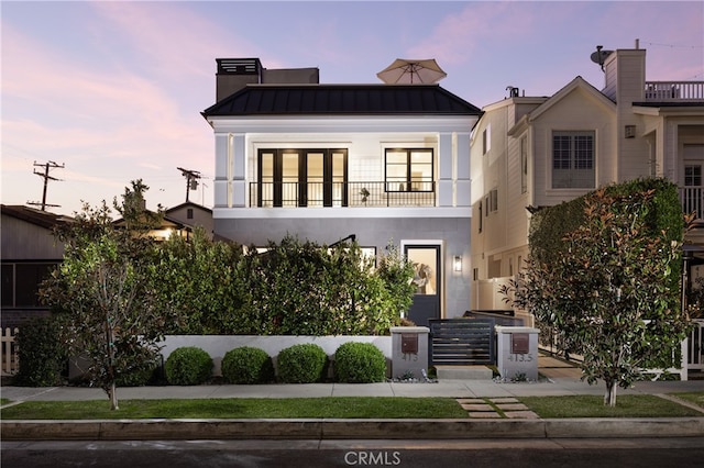 view of front of property with a balcony