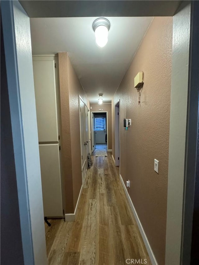 corridor featuring hardwood / wood-style floors