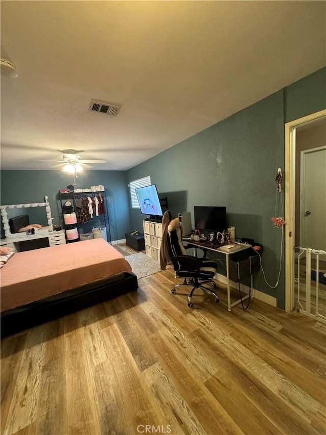 bedroom with wood-type flooring and ceiling fan