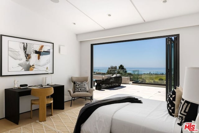 bedroom featuring a water view and light hardwood / wood-style floors