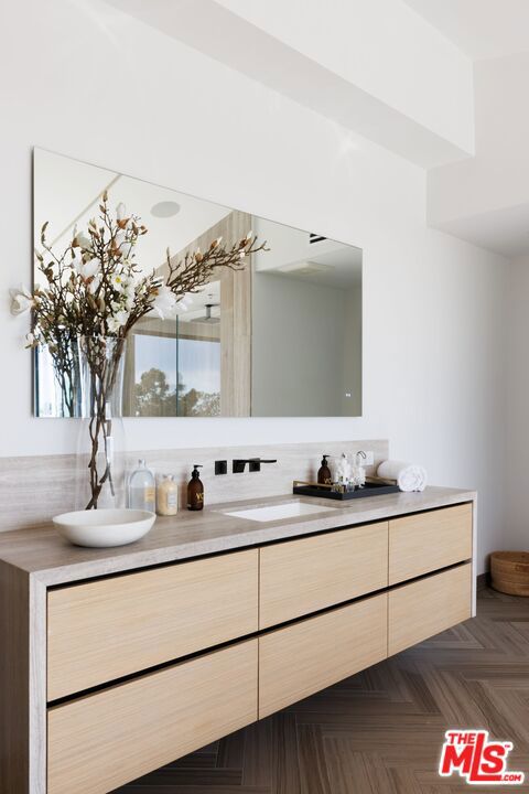 bathroom featuring vanity and parquet flooring