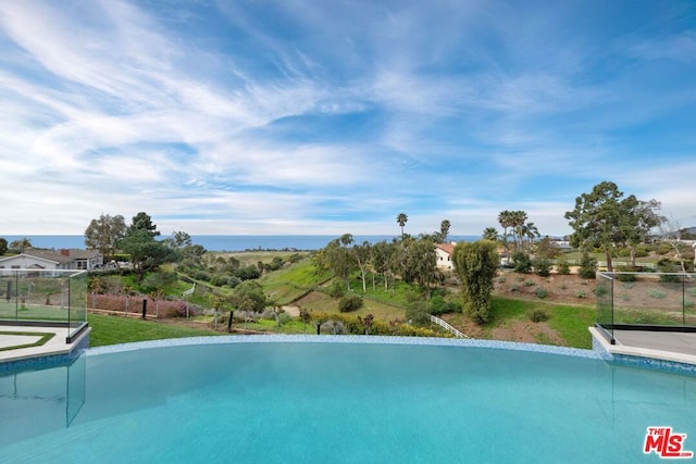 view of pool with a water view