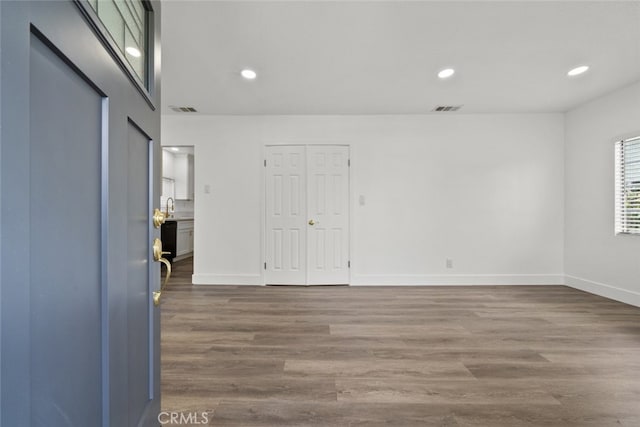 empty room featuring wood-type flooring and sink