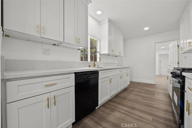 kitchen featuring black appliances, dark hardwood / wood-style floors, sink, and white cabinets