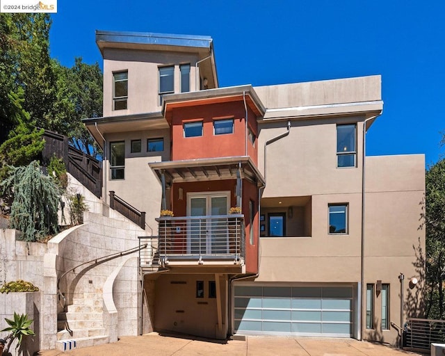 view of front of property with a garage and a balcony