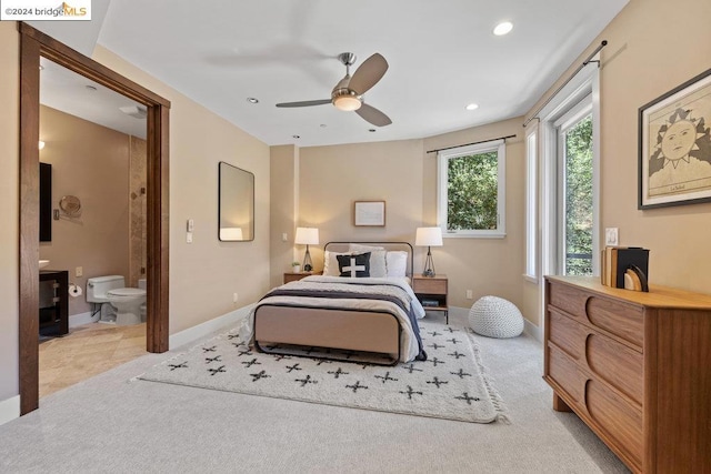 bedroom with ensuite bathroom and ceiling fan