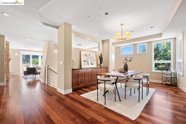 dining area with a notable chandelier and dark wood-type flooring