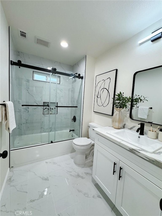 full bathroom featuring vanity, bath / shower combo with glass door, and toilet