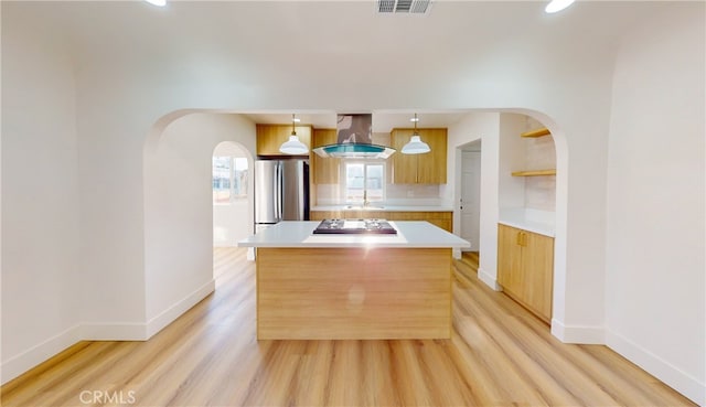 kitchen featuring a kitchen island, pendant lighting, stainless steel appliances, island exhaust hood, and light wood-type flooring