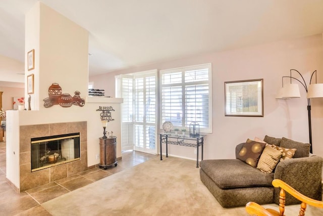 living area featuring tile patterned flooring and a tiled fireplace