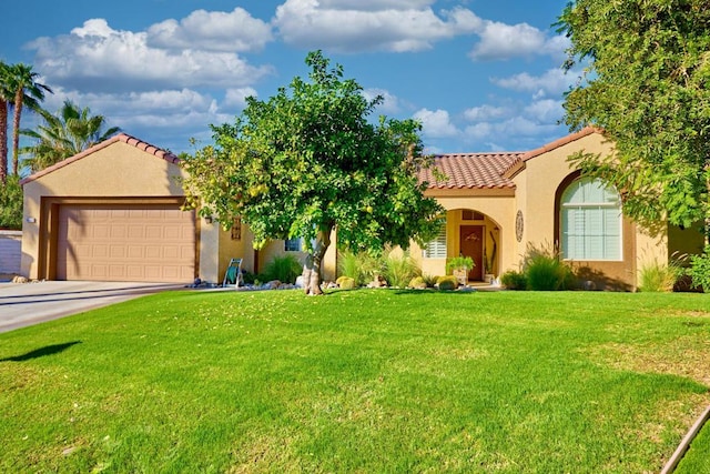 mediterranean / spanish home featuring a garage and a front lawn