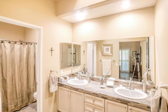 bathroom with vanity, toilet, and curtained shower