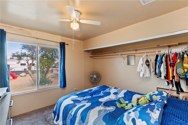 carpeted bedroom featuring a closet and ceiling fan