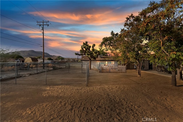 yard at dusk featuring a mountain view