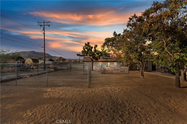 view of yard featuring fence and a mountain view