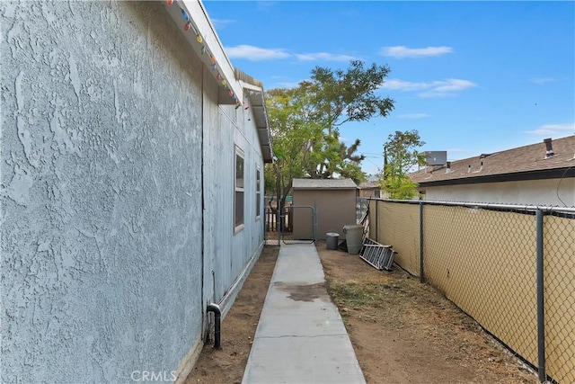 view of property exterior featuring stucco siding and fence