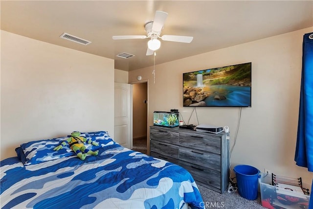carpeted bedroom with visible vents and a ceiling fan