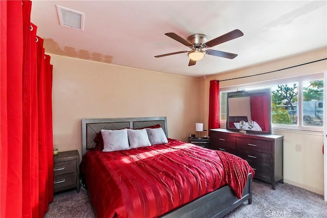 bedroom with carpet, visible vents, and ceiling fan