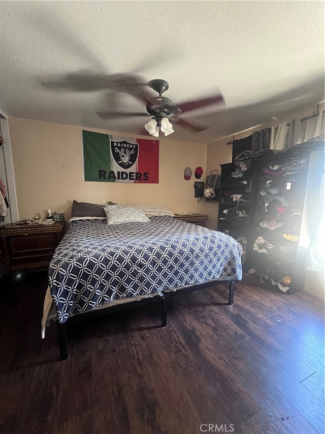 bedroom featuring wood-type flooring, ceiling fan, and a textured ceiling