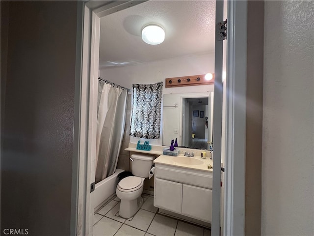 full bathroom featuring vanity, a textured ceiling, tile patterned flooring, shower / tub combo with curtain, and toilet