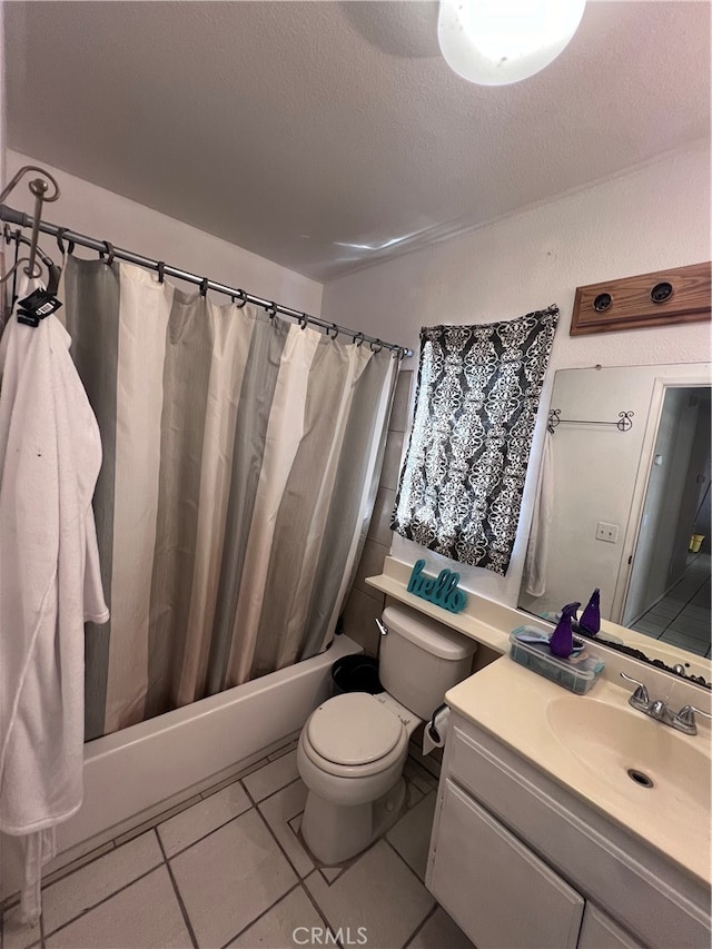 full bathroom with tile patterned flooring, shower / bath combo, a textured ceiling, vanity, and toilet