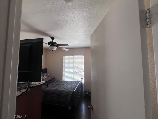 bedroom with a textured ceiling and ceiling fan