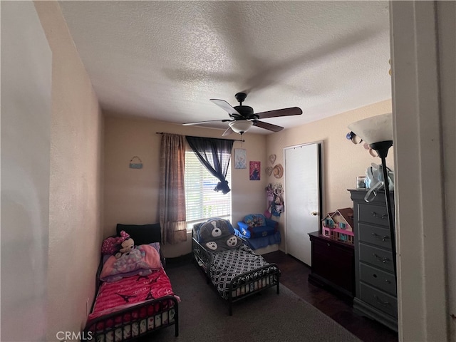 bedroom with a textured ceiling and ceiling fan