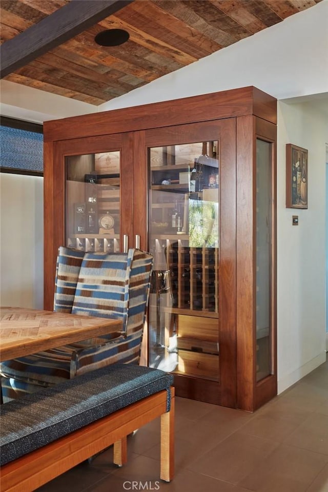 wine area featuring brick ceiling, lofted ceiling, and tile patterned flooring