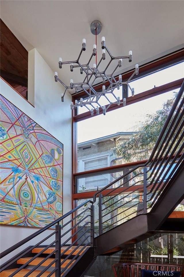 staircase featuring a chandelier