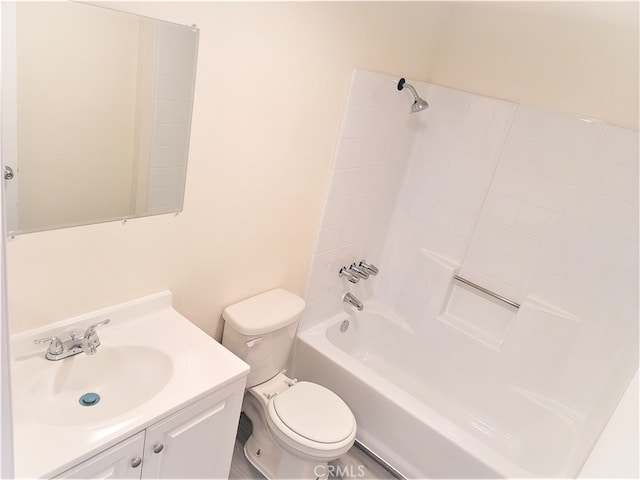 full bathroom featuring vanity, tiled shower / bath, and toilet