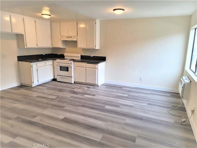 kitchen with light hardwood / wood-style floors, sink, white cabinets, white range with gas stovetop, and a wall mounted AC