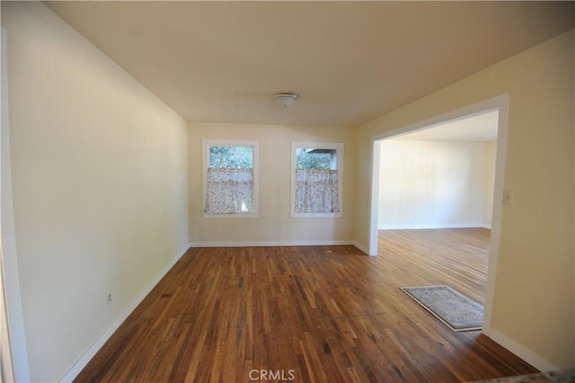 empty room with dark hardwood / wood-style floors