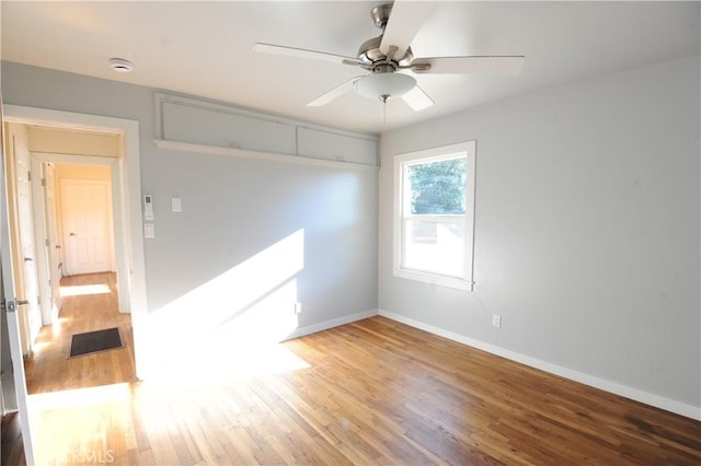 spare room with hardwood / wood-style flooring and ceiling fan