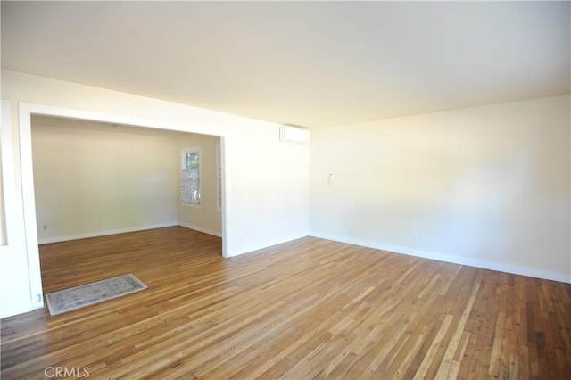 unfurnished room featuring hardwood / wood-style flooring