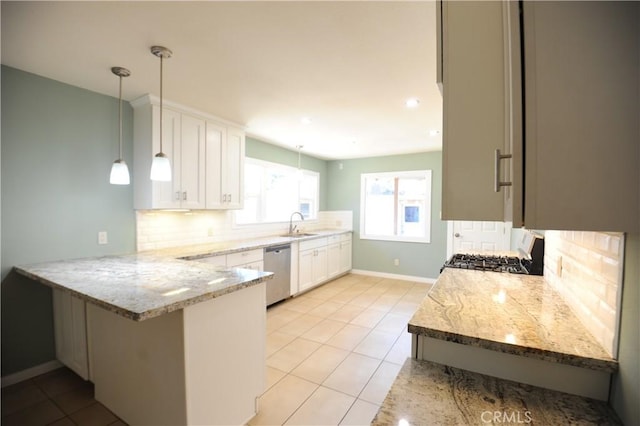 kitchen featuring hanging light fixtures, stove, stainless steel dishwasher, white cabinets, and kitchen peninsula