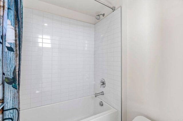 bathroom featuring toilet and shower / tub combo with curtain