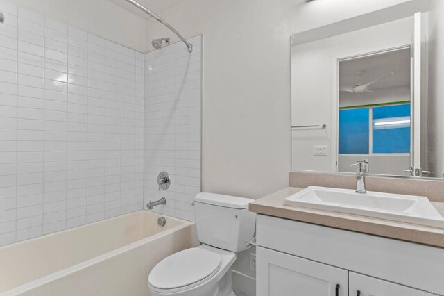 full bathroom featuring vanity, toilet, and tiled shower / bath combo