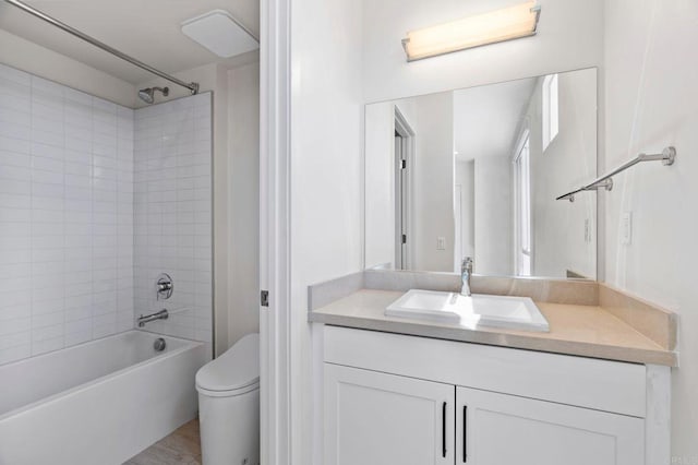 full bathroom with vanity, toilet, and tiled shower / bath