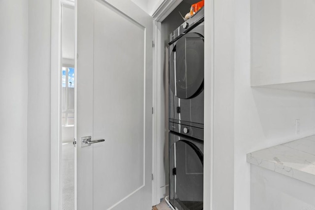 laundry room with stacked washer / drying machine