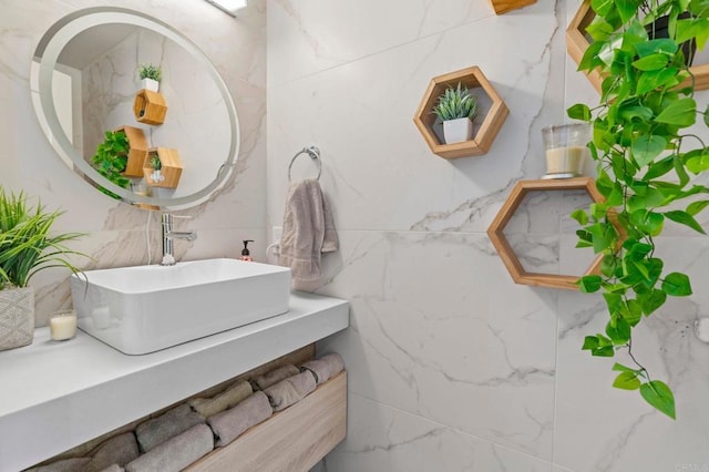 bathroom featuring vanity and tile walls