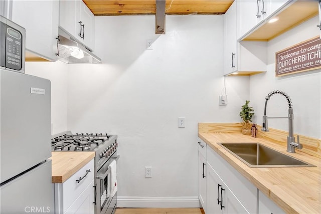 kitchen with sink, stainless steel appliances, and white cabinets