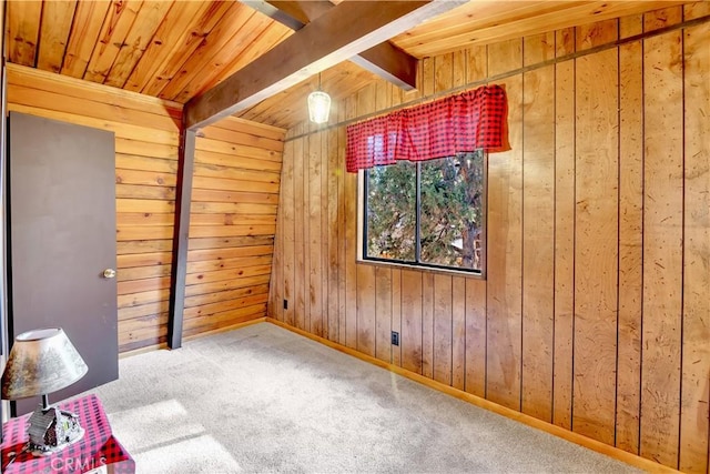 carpeted spare room featuring wooden ceiling, beam ceiling, and wood walls