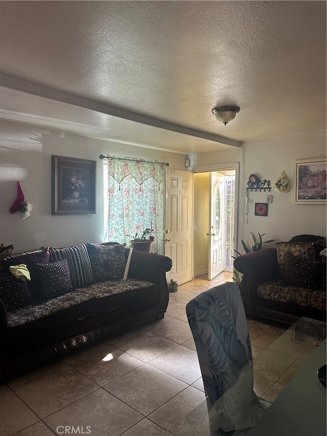 tiled living room featuring a textured ceiling