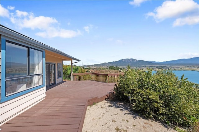 wooden deck featuring a water and mountain view