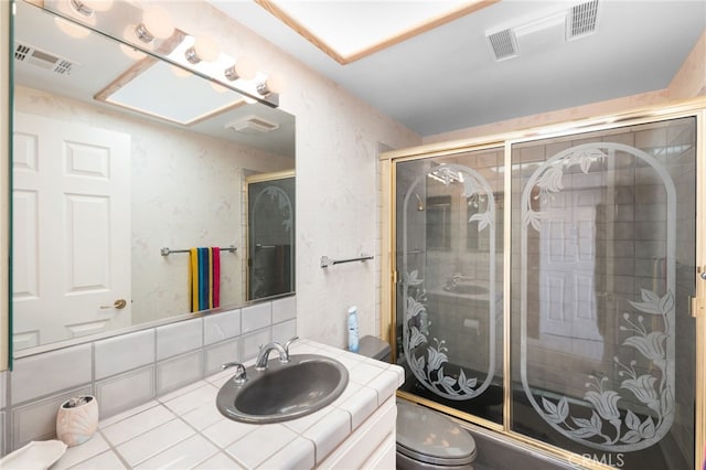 bathroom featuring walk in shower, vanity, decorative backsplash, and toilet